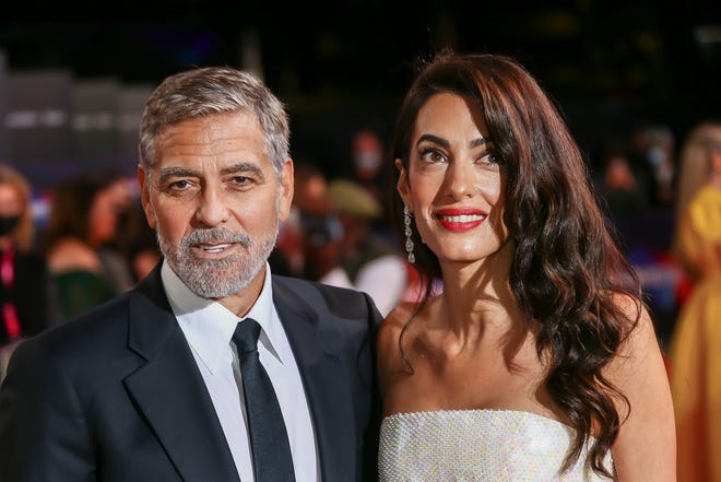 George and Amal Clooney pose for photographers upon arrival at the premiere of the film 'The Tender Bar' during the 2021 BFI London Film Festival in London, Sunday, Oct. 10, 2021.