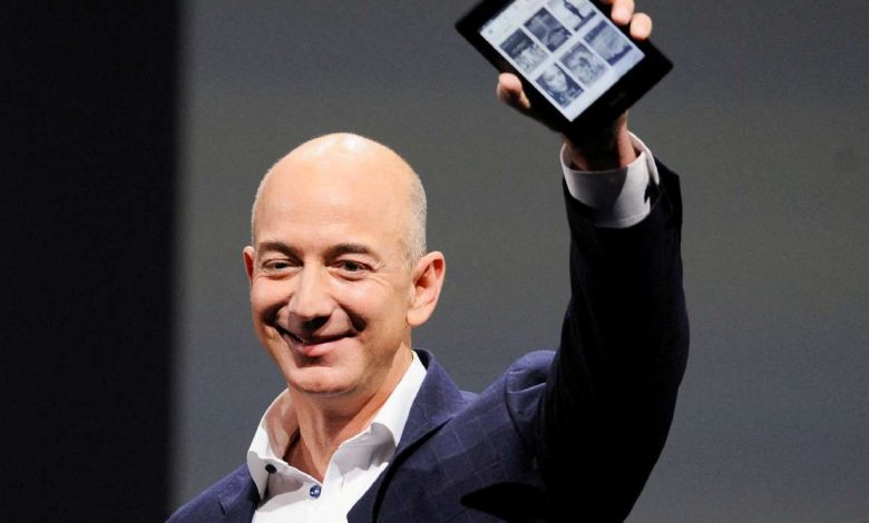 Amazon CEO Jeff Bezos holds up a Kindle Paperwhite during Amazon's Kindle Fire event in Santa Monica, California Sept. 6, 2012.