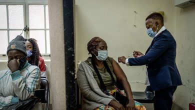 A woman is vaccinated against COVID-19 at the Hillbrow Clinic in Johannesburg, South Africa, on Monday Dec. 6, 2021. South African doctors say the rapid increase in COVID-19 cases attributed to the new omicron variant is resulting in mostly mild symptoms.