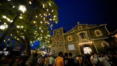 Filipino residents walk outside the St. Joseph Parish Church after attending the first of nine daily dawn masses before Christmas day in suburban Las Pinas city, Philippines on Thursday, Dec. 16, 2021. Filipinos attend nine consecutive dawn masses before Christmas as part of traditional Filipino practice in this largely Roman Catholic nation.