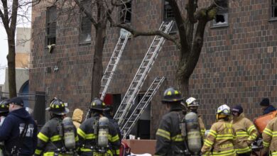 Ladders are seen erected beside the apartment building where a fire occurred in the Bronx on Sunday, in New York.