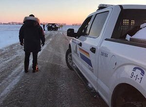 This handout photo released on January 19, 2022 by the Royal Canadian Mounted Police (RCMP) in Emerson, Manitoba shows RCMP officers on the scene where four people were found dead near the Canada/US border.