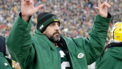 Aaron Rodgers acknowledges the fans at Lambeau Field as they cheer after the quarterback broke the Packers' all-time passing touchdowns record.