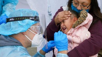 In this Nov. 10, 2020, file photo, Kim Tapia holds her granddaughter Amariah Lucero, 3, as she's tested at the Utah National Guard's mobile testing site for COVID-19 in Salt Lake City. Utah reported far fewer coronavirus cases in the week ending Sunday, adding 6,006 new cases during the holiday week. The number of reported cases was down 14.4% from the previous week's tally of 7,016 new cases of the virus that causes COVID-19.
