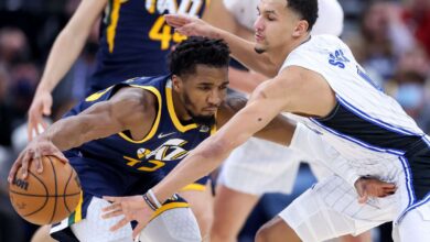 Utah Jazz guard Donovan Mitchell (45) moves against Orlando Magic guard Jalen Suggs (4) during the game at Vivint Arena in Salt Lake City on Friday, Feb. 11, 2022.