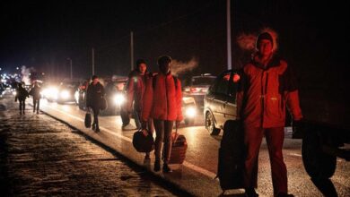 People on foot and in cars move to cross from Ukraine to Poland at the Korczowa-Krakovets border crossing on February 26, 2022, following the Russian invasion of Ukraine.