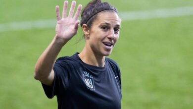 NJ/NY Gotham FC's Carli Lloyd waves to young fans before the team's NWSL soccer match against the Washington Spirit.