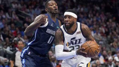 Dallas Mavericks forward Dorian Finney-Smith (10) defends as Utah Jazz forward Royce O'Neale (23) works to the basket in the first half of an NBA basketball game in Dallas.
