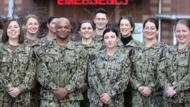 Members of the U.S. Navy, including physicians, nurses and respiratory therapists, pose for a photo as they arrived to support the University of Utah Hospital in Salt Lake City on March 2. Their deployment ended Wednesday.