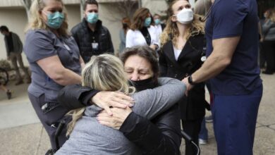 Cindy Rogers, St. Mark’s Hospital occupational therapy assistant, hugs Michelle Liechty, who spent 70 days at the hospital fighting COVID-19 and its aftereffects, during a COVID-19 memorial ceremony outside of St. Mark’s Hospital in Millcreek on Wednesday.