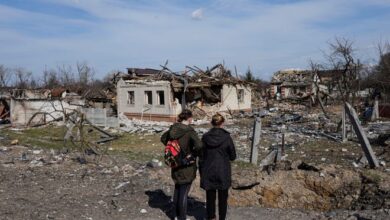 Women look at houses damaged by shelling in Chernihiv, Ukraine, on April 7, 2022.